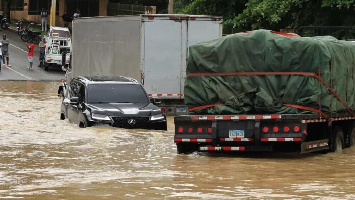 Conductor arrastrado por río en inundación