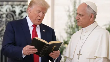 Trump lee la Biblia en evento religioso.